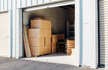 Modern climate-controlled storage facility with neatly stacked furniture boxes in secure storage units